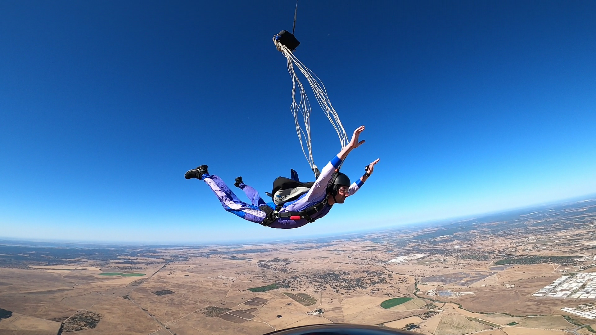 Pilot chute deploying above the horizon