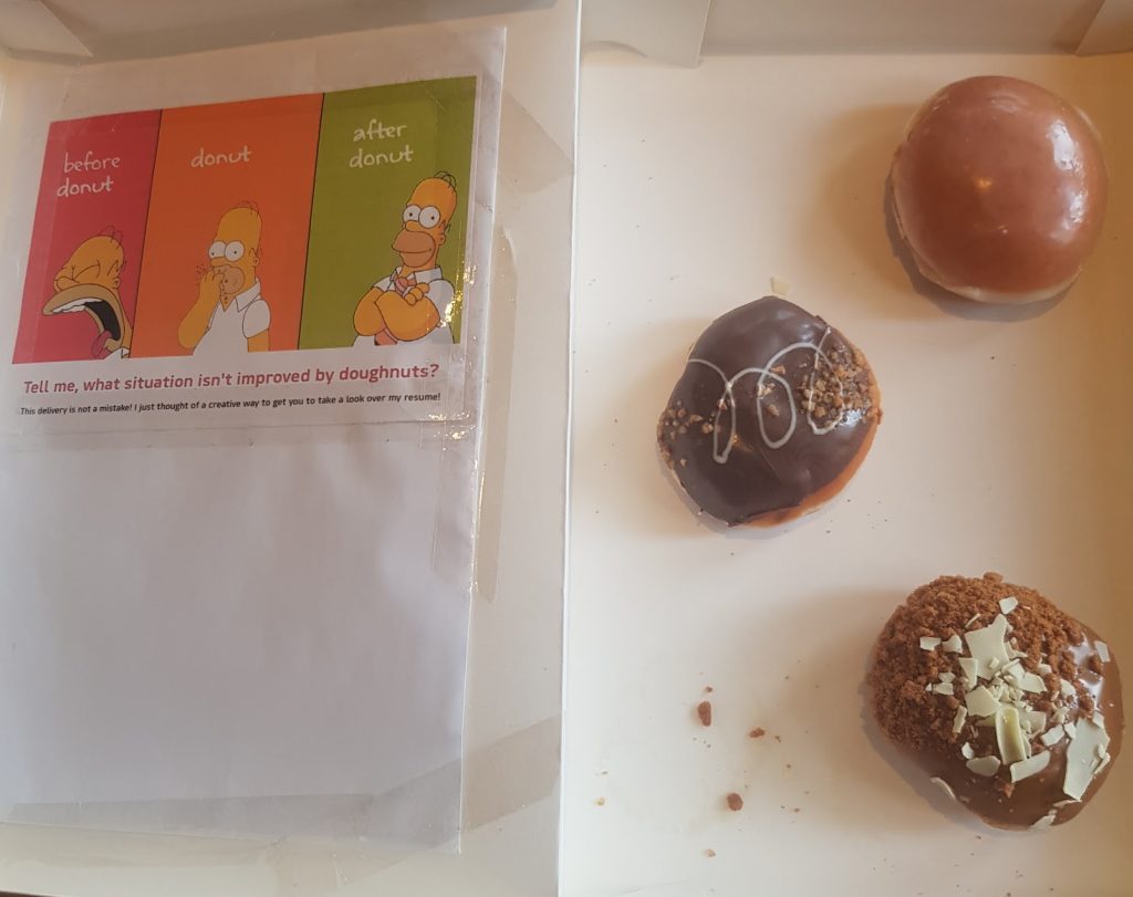 Creative resume page showing Homer Simpson before, during, and after eating a donut with the caption: 'Tell me, what situation isn't improved by doughnuts?