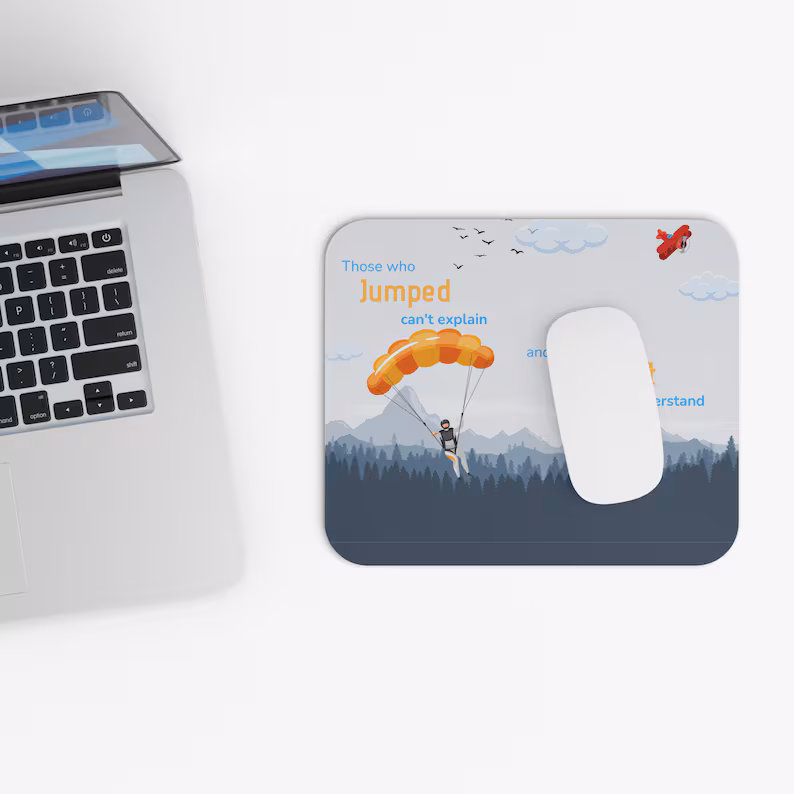 Skydiving mouse pad with an inspirational quote, shown on a desk next to a laptop, making it a perfect office gift for a skydiver.