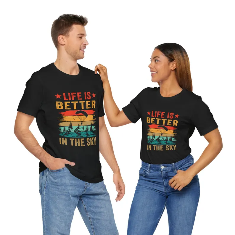 Skydiving t-shirt with a retro 'Life is Better in the Sky' design, worn by a man and a woman, making it a great gift idea for skydivers.